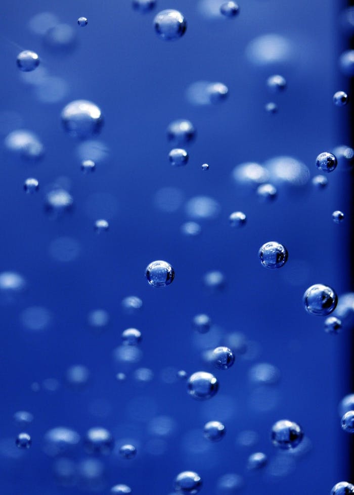 Captivating image of water bubbles in vibrant blue, showcasing texture and clarity.
